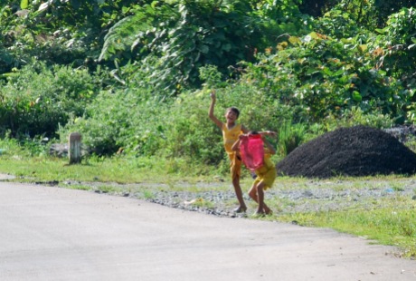 Children running to the road to shout out a 'hello'! as we pass by